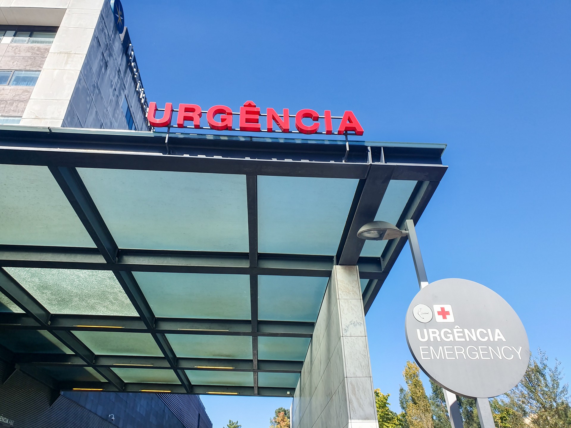 Hospital entrance with emergency sign in red.